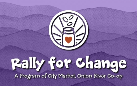 White circle logo with coins, rays and a jar with a red heart on it below the coins. The text below the icon reads "Rally for Change A Program of City Market Onion River Co-op." The text and circle icon are on top of a purple water colored background.