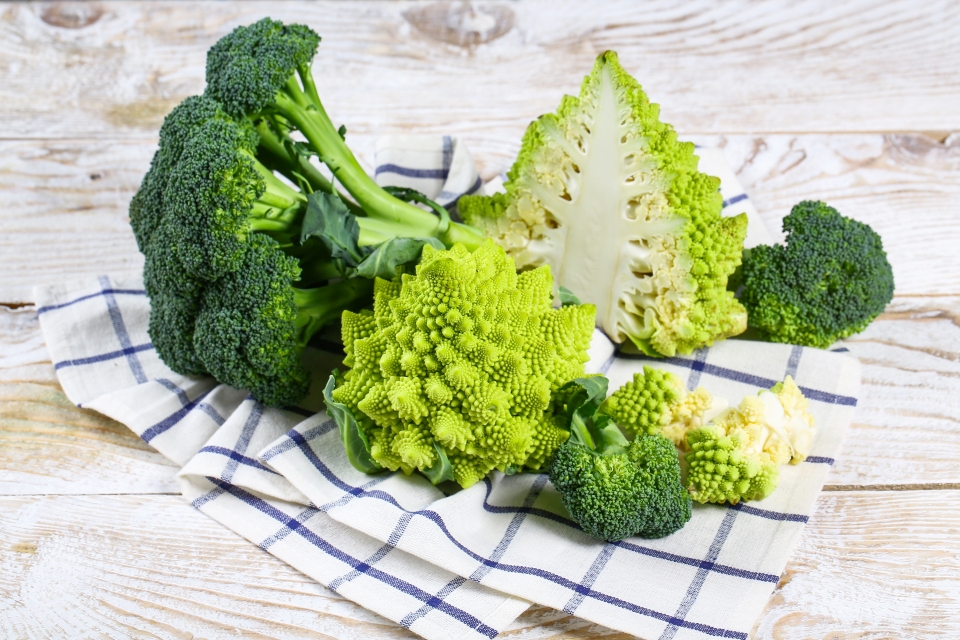 broccoli and romanesco laid on a plaid dishcloth