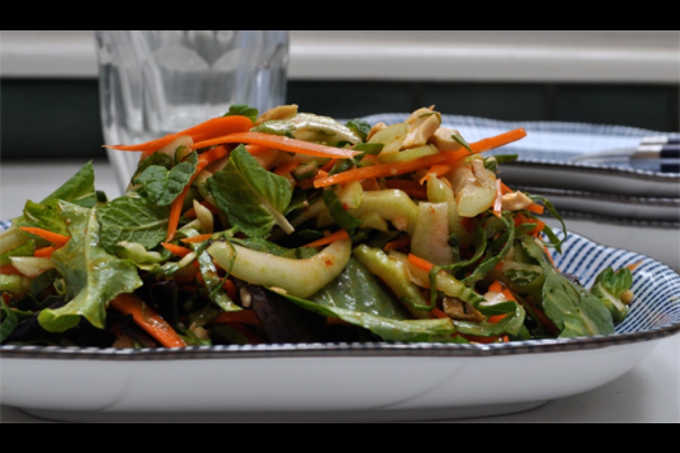 Bok choy and carrots sit on a plate! Chopped into a salad!