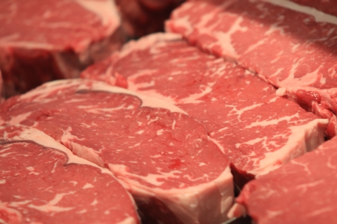A close-up of several cuts of marbled beef. 