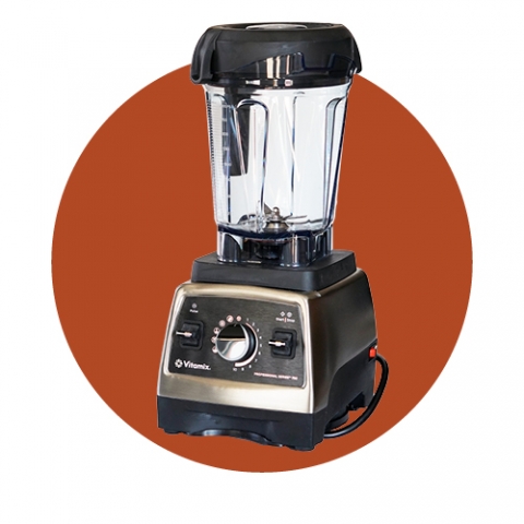 A Vitamix Blender in front of a rust red circle
