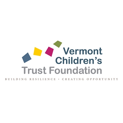 Blue and gray words on a white background that read "Vermont Children's Trust Foundation." There are four four-sided irregular polygons along the top left of the wording. Each polygon is a different color: the first is blue, the second is yellow, the third is magenta, and the fourth is green.