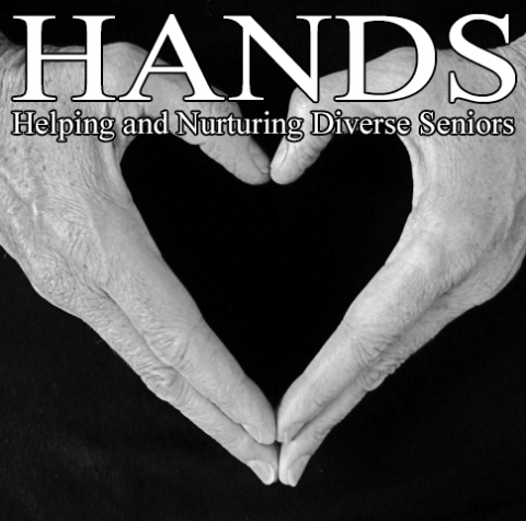 Two hands viewed from the top down against a black background. Together they form the shape of a heart, with the thumbs forming the point at the top and the fingers forming the point at the bottom. The words "HANDS - Helping and Nurturing Diverse seniors" are printed over the hands.
