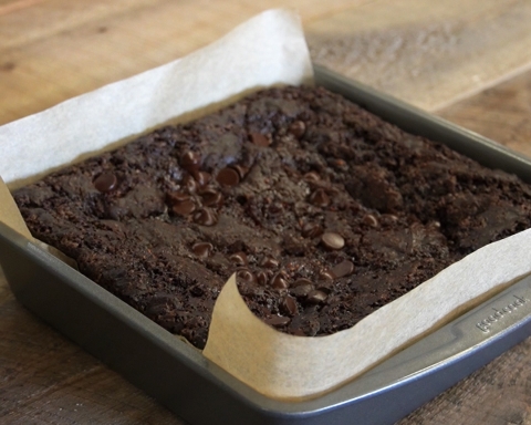 Vegan brownies sit in a pan on a wooden table!