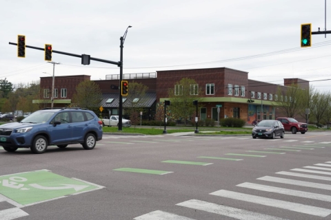 Cars crossing Flynn Ave in front of the City Market South End store 