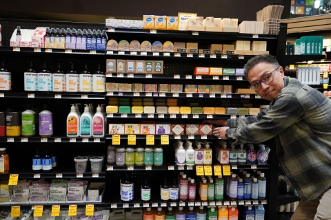 The Wellness Manager at City Market's downtown location stands in front of personal care products on the shelf