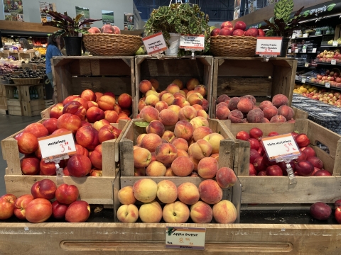 Peaches in wooden crates in the store