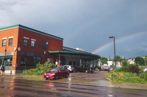 a double rainbow behind the downtown City Market building