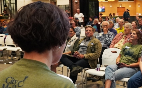 a board member addresses the crowd at member meeting