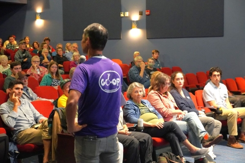 John Tashiro addressing Members in an auditorium at the annual Member Meeting 2025