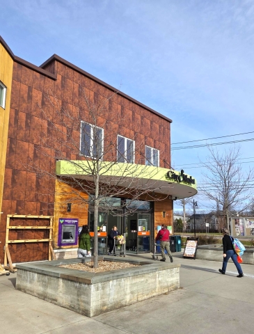 people walking into a grocery store