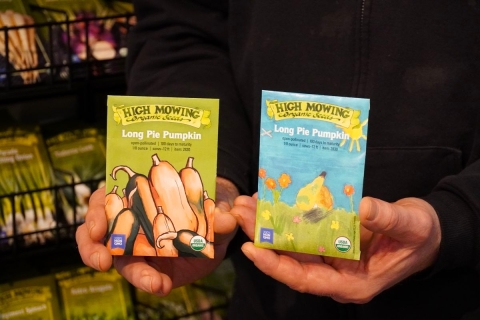 a man holds pumpkin seed packets