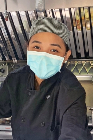 Photo of a masked cooking student