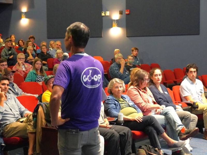 John Tashiro addressing Members in an auditorium at the annual Member Meeting 2025